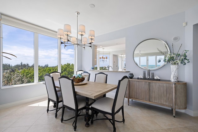 dining space with light tile patterned floors and an inviting chandelier