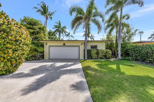 view of front of house with a front lawn and a garage