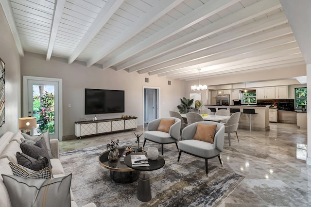 living room with beam ceiling and a chandelier