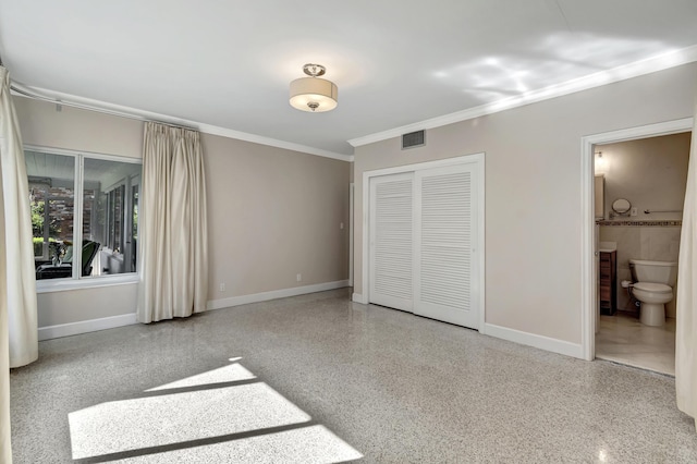 unfurnished bedroom with ensuite bathroom, crown molding, and a closet