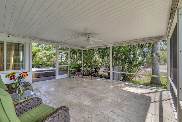 sunroom featuring ceiling fan