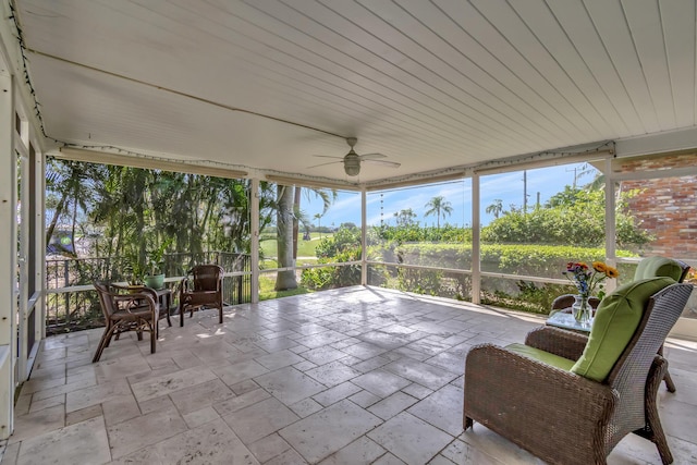 unfurnished sunroom with a healthy amount of sunlight and ceiling fan