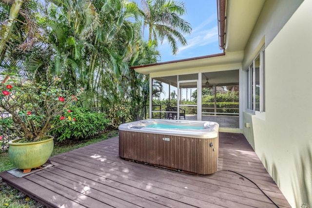 wooden terrace featuring a hot tub, a sunroom, and cooling unit