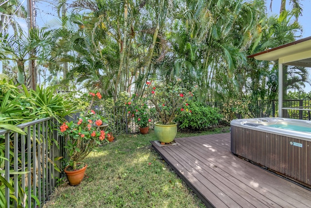 wooden terrace featuring a hot tub