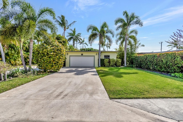 view of front of home with a garage and a front lawn