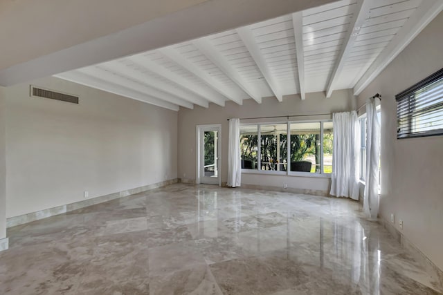 unfurnished room with beam ceiling and plenty of natural light