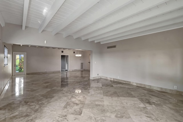 empty room with an inviting chandelier and beamed ceiling