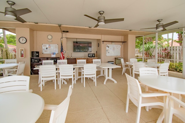 dining space with light tile patterned floors and ceiling fan