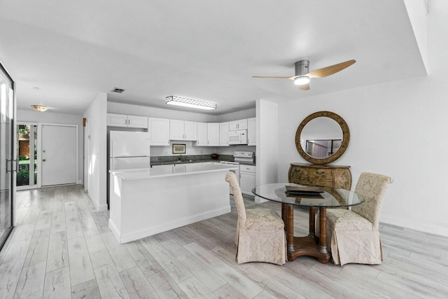 dining room featuring ceiling fan and light hardwood / wood-style floors