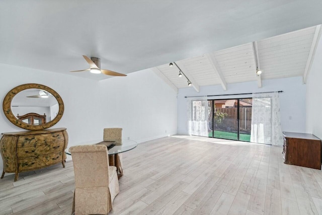 unfurnished room featuring ceiling fan, rail lighting, light hardwood / wood-style flooring, lofted ceiling with beams, and wood ceiling