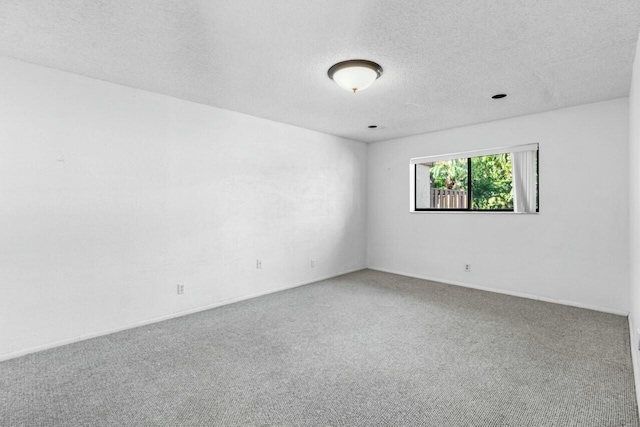 unfurnished room featuring carpet floors and a textured ceiling