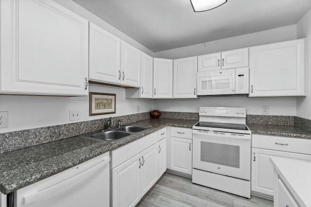 kitchen featuring white cabinets, white appliances, light hardwood / wood-style flooring, and sink