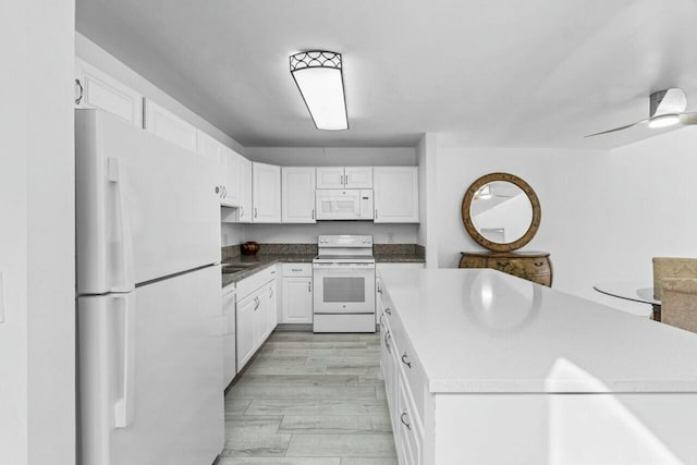 kitchen featuring ceiling fan, light hardwood / wood-style flooring, white cabinets, and white appliances