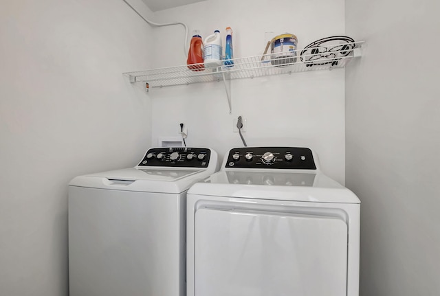 clothes washing area featuring washer and dryer and laundry area