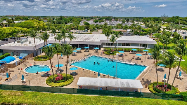 community pool featuring a patio and fence