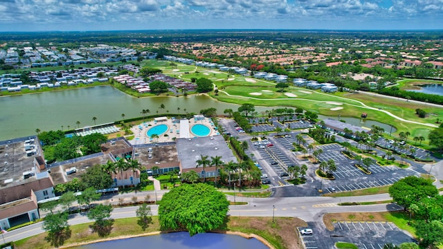 birds eye view of property featuring a water view and view of golf course