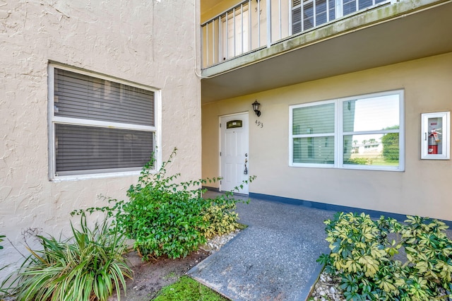 entrance to property with stucco siding