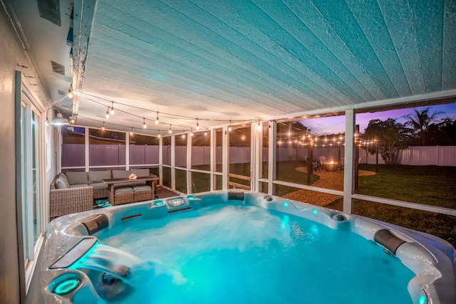 pool at dusk with an outdoor living space and a yard