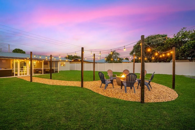 yard at dusk featuring a fire pit