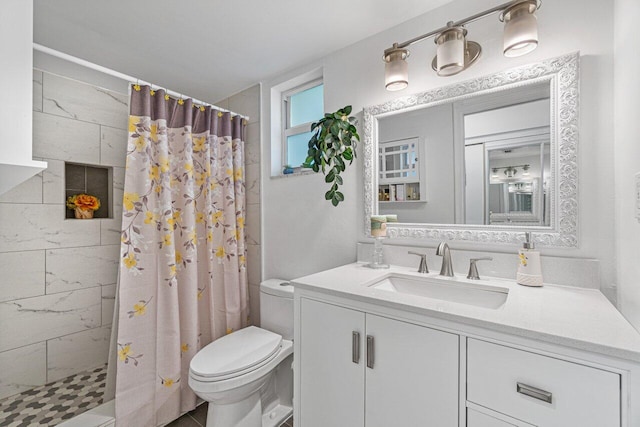 bathroom with walk in shower, vanity, and toilet