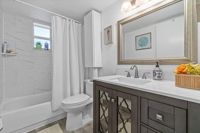 full bathroom featuring shower / bath combo with shower curtain, vanity, hardwood / wood-style floors, and toilet