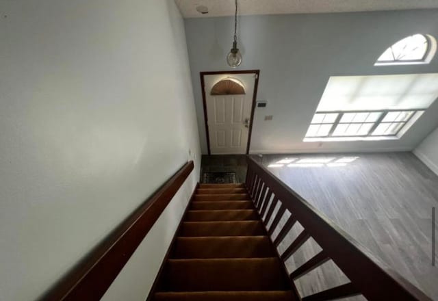 stairway with dark wood-type flooring