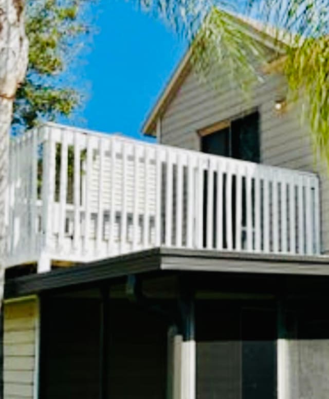 view of side of home with a balcony