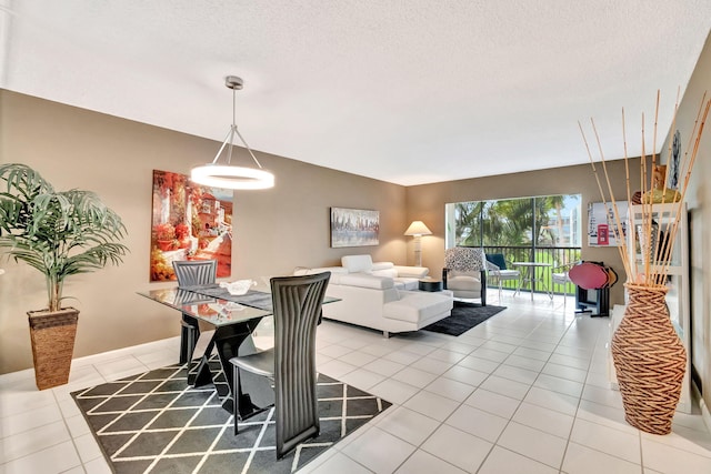 dining space with light tile patterned floors and a textured ceiling