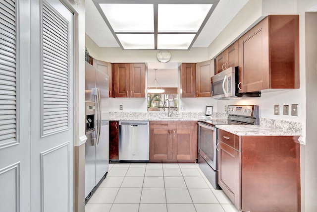 kitchen with light stone countertops, light tile patterned floors, stainless steel appliances, and sink