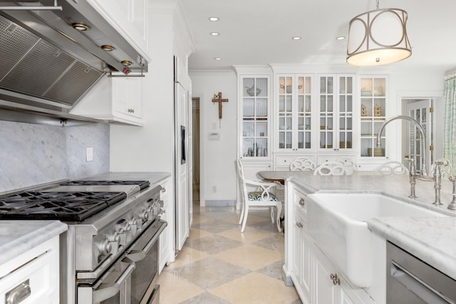 kitchen with a sink, stainless steel appliances, crown molding, wall chimney exhaust hood, and backsplash