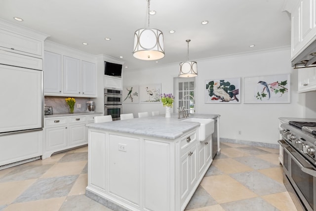 kitchen with backsplash, high quality appliances, ornamental molding, white cabinetry, and a sink