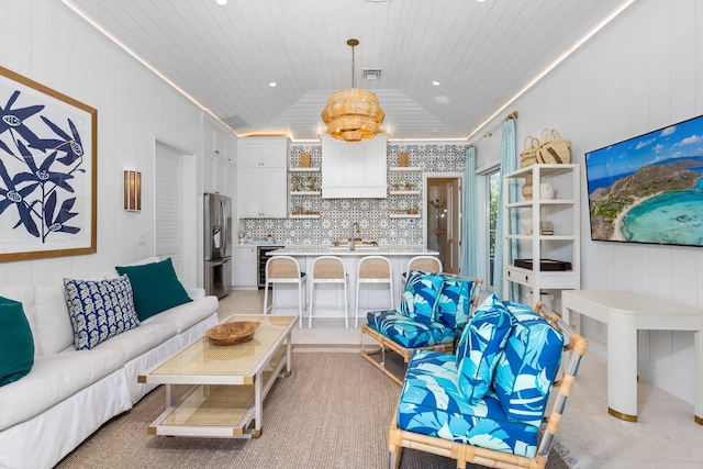 living room featuring vaulted ceiling and wood ceiling