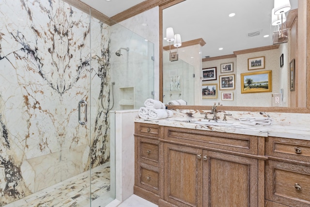 bathroom featuring a marble finish shower, vanity, and ornamental molding