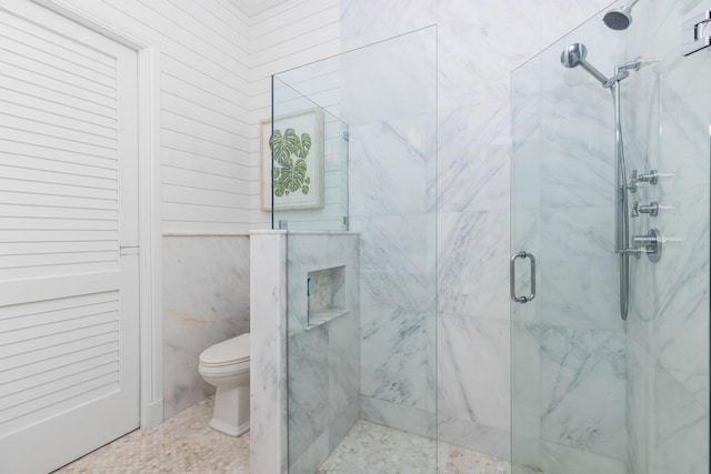 full bathroom with a marble finish shower and toilet