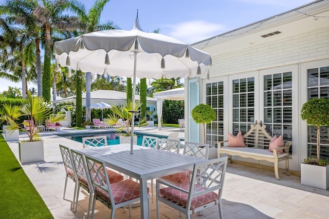 view of patio featuring an outdoor pool, french doors, and outdoor dining area