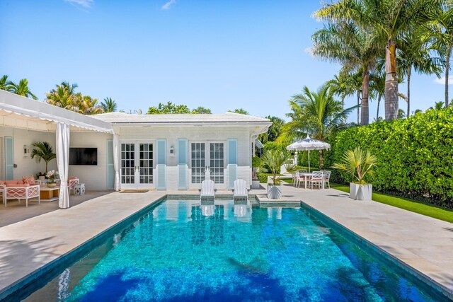 pool with a patio area and french doors