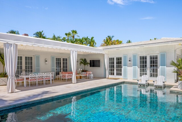 view of pool with a patio area and french doors