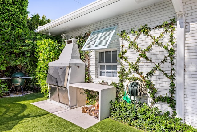 exterior space featuring brick siding and a yard