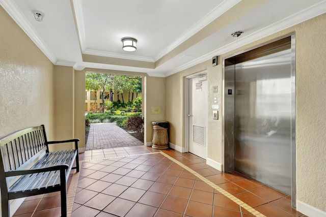 interior space with a tray ceiling, ornamental molding, tile patterned floors, and elevator