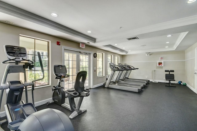 workout area featuring crown molding and a tray ceiling