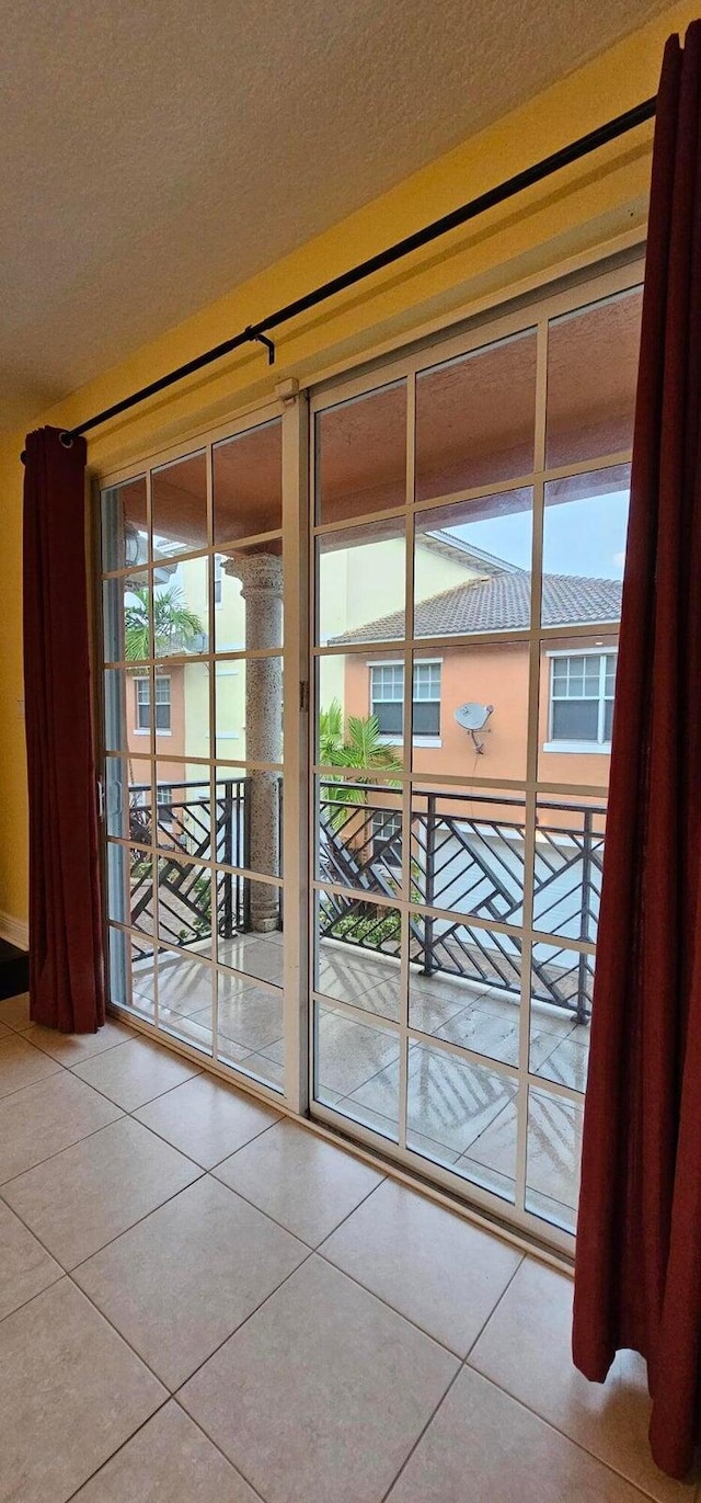 doorway featuring tile patterned flooring and plenty of natural light