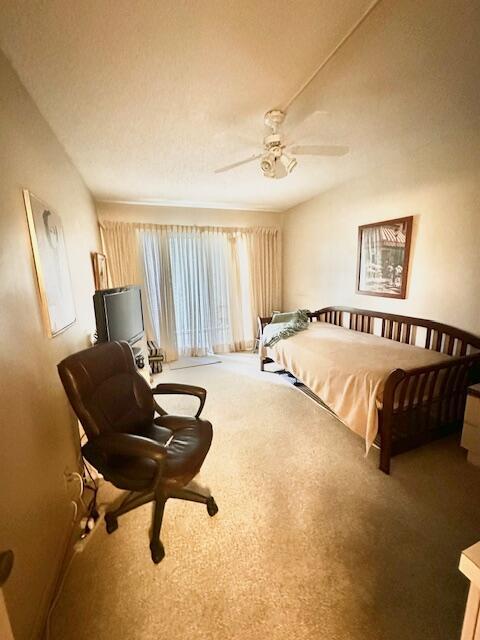 bedroom featuring ceiling fan and carpet