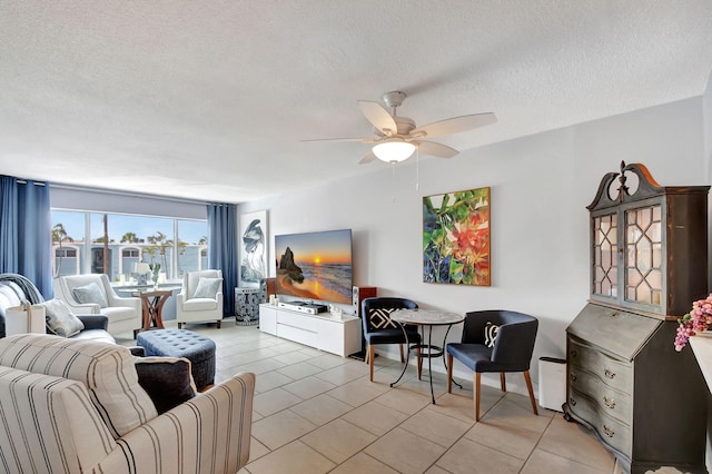 tiled living room with ceiling fan and a textured ceiling