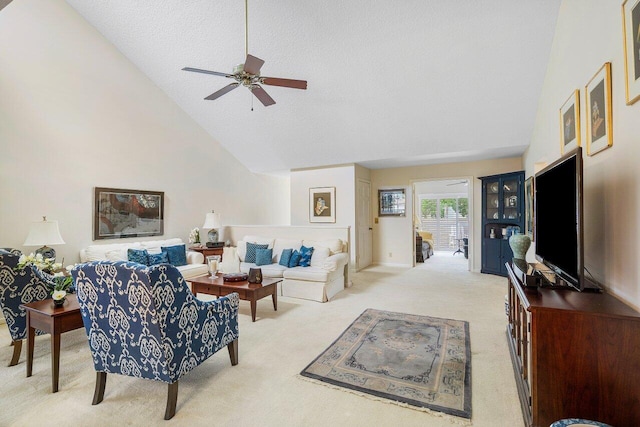 living room featuring a textured ceiling, ceiling fan, light carpet, and high vaulted ceiling