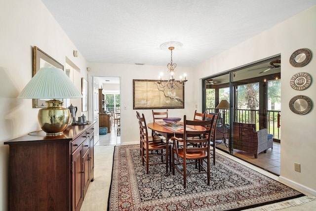 dining room with light carpet, a textured ceiling, a healthy amount of sunlight, and an inviting chandelier