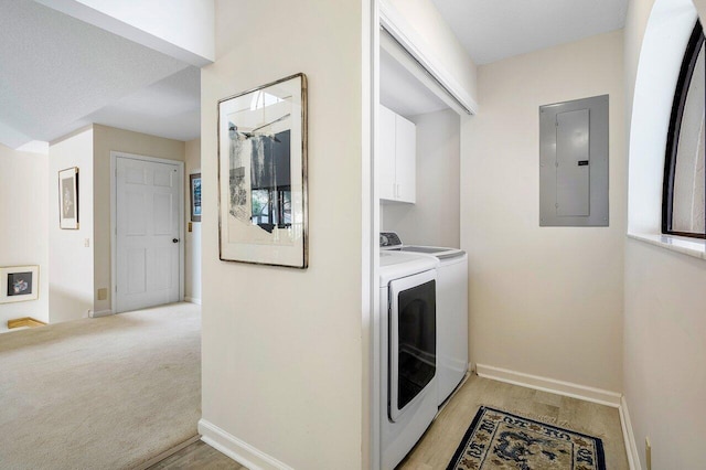 washroom with light colored carpet, electric panel, cabinets, washer and clothes dryer, and a textured ceiling