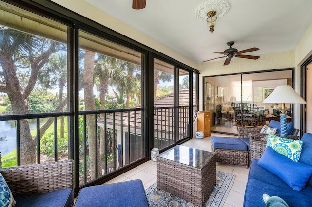 sunroom / solarium featuring plenty of natural light and ceiling fan