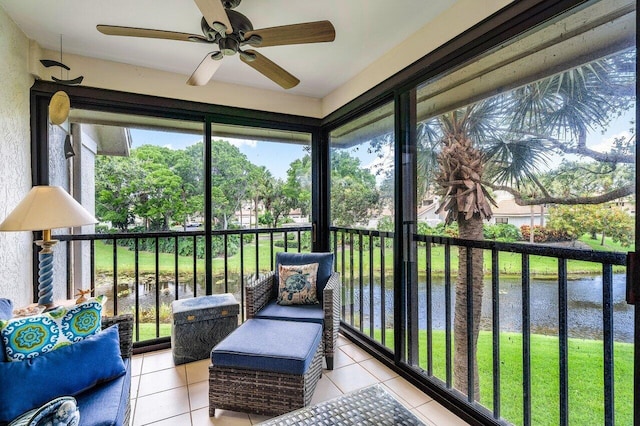 sunroom / solarium with a water view, ceiling fan, and plenty of natural light