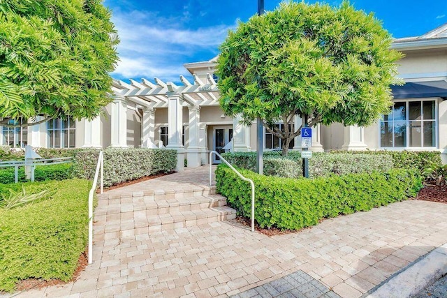 view of front of property with a pergola