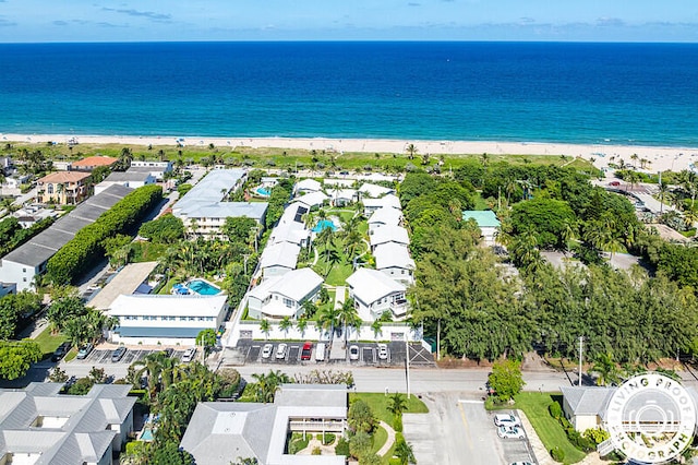 bird's eye view with a water view and a beach view